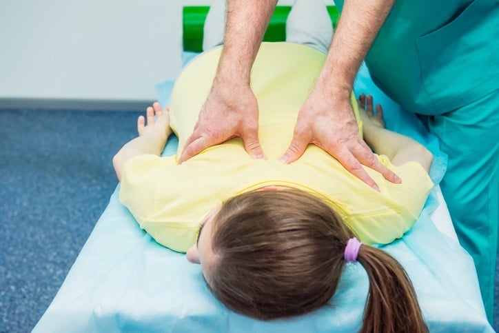 Chiropractor Adjusting a Back in Greenfield, FL