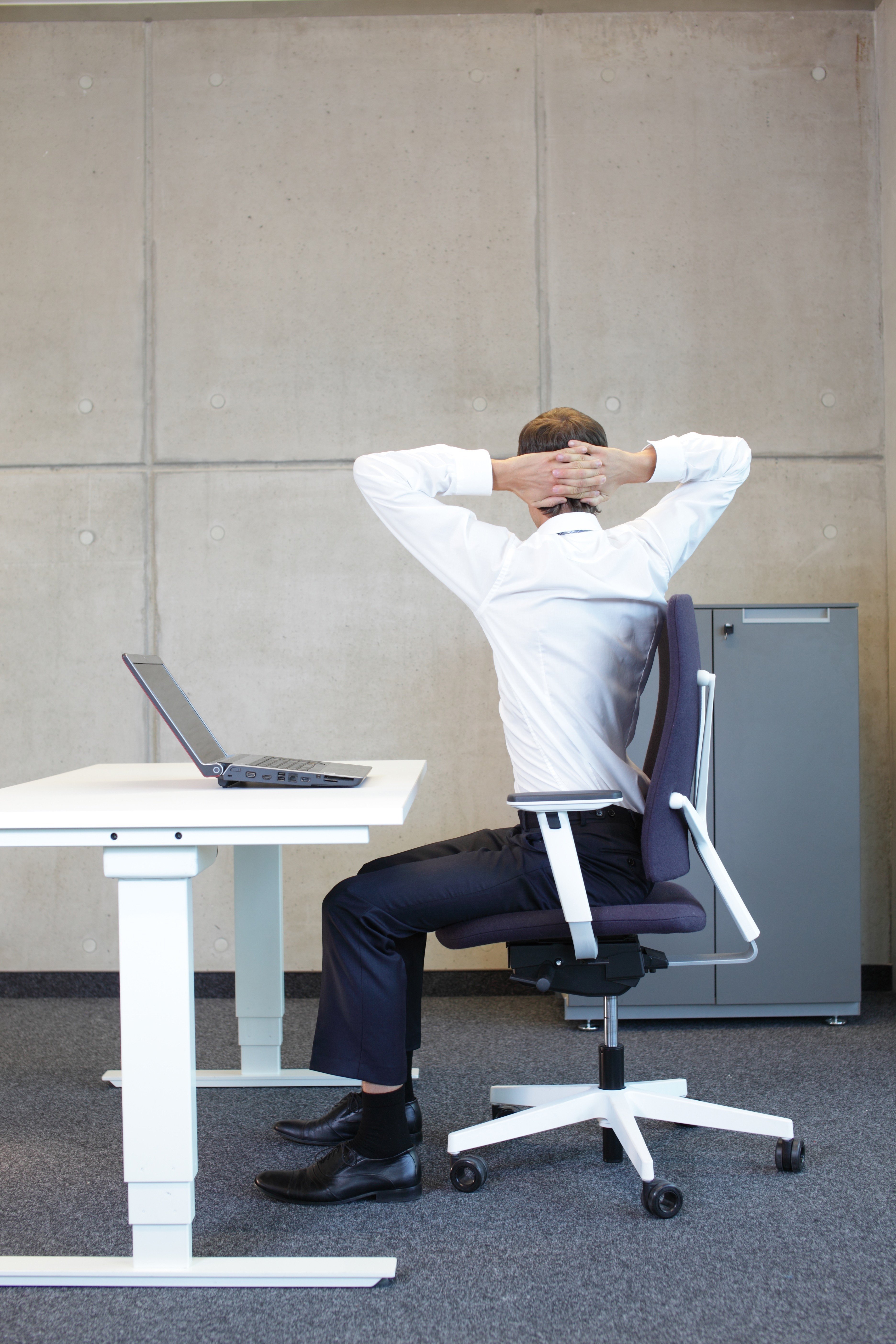 Man with Lower Back Pain from his Desk Chair